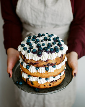 Woman with blueberry cake