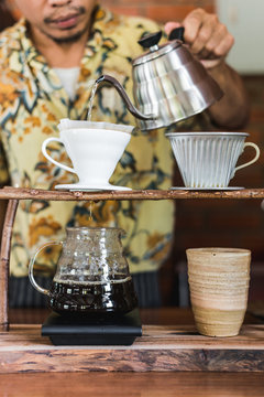 Asian barista making drip coffee