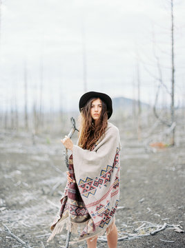 An outdoor style portrait of a girl wearing a poncho
