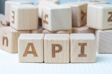 API, Application programming interface concept, cube wooden block with alphabet combine...