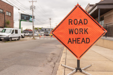 Road work ahead sign on street