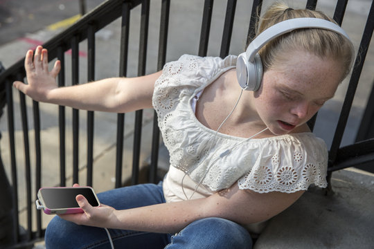 A young adult listening to music