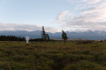 Spaceman standing in green field