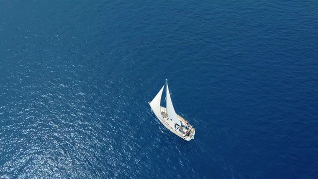 Yacht sailing on opened sea. Sailing boat. Yacht from drone. Yachting video. Yacht from above. Sailboat from drone. Sailing video. Yachting at windy day. Yacht. Sailboat.