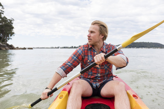 A man paddling his kayak around Ku-ring-gai Chase NP
