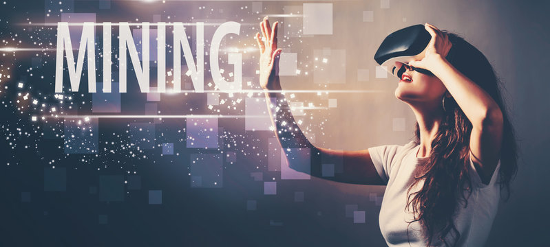 Mining with young woman using a virtual reality headset - Powered by Adobe