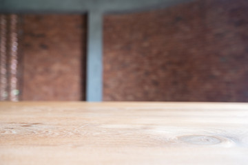 Closeup image of vintage wooden table with blur brick wall background