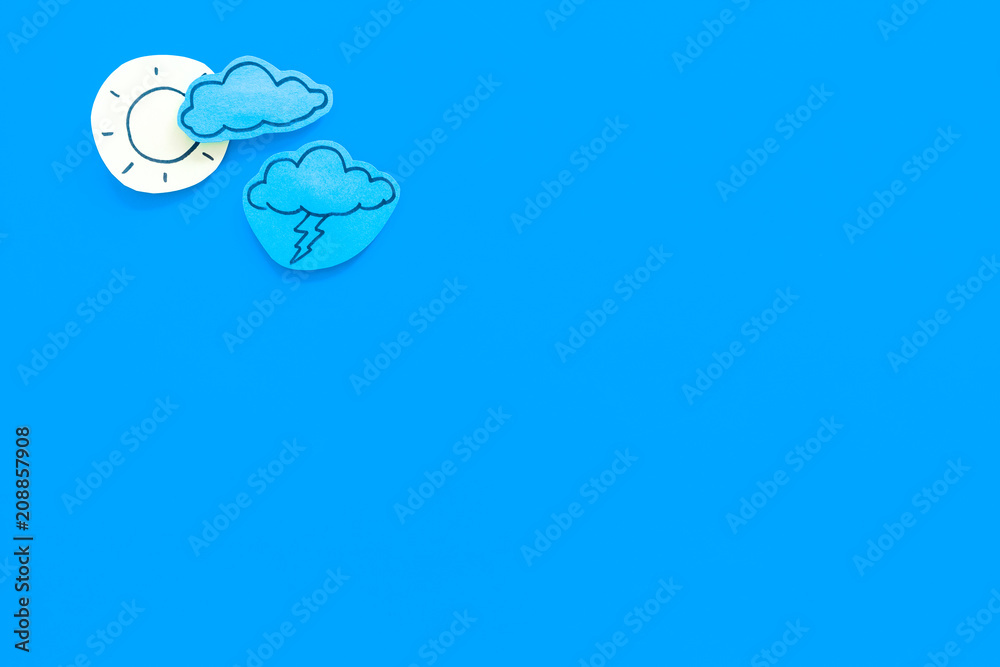 Wall mural clear and cloudly weather icons on blue background top view copy space