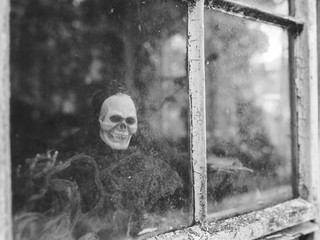 A ghoulish figure at an old window