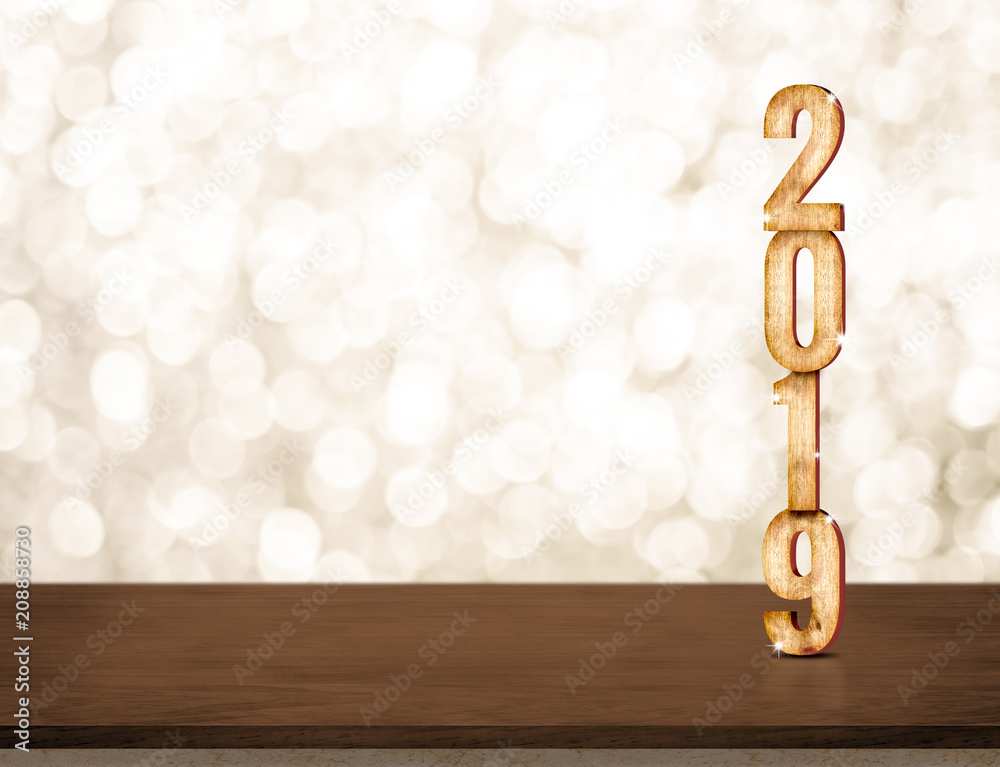 Poster happy new year 2019 gold glossy with sparkling star on dark brown table with gold bokeh wall,holiday