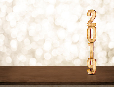 Happy New Year 2019 gold glossy with sparkling star on dark brown table with gold bokeh wall,Holiday festive celebration concept.copy space for display of text or content.
