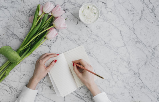 Woman Writing in Notebook