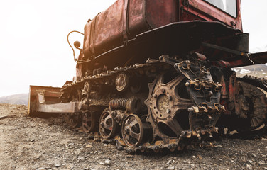 Old dirty bulldozer in a mountainous area © Tycsan