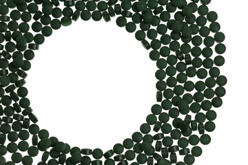 Algae spirulina in tablets .round frame of spirulina tablets isolated on white background.spirulina Mockup.dietary supplement.Super food