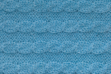Fototapeta premium Light blue knitting texture with aran pattern, horizontal knit cable background
