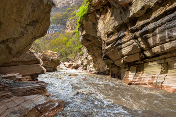 Mountain river stretching along the cliffs
