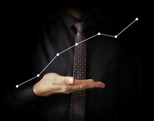 Businessman with financial symbols coming