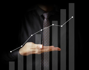 Businessman with financial symbols coming