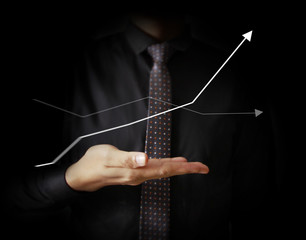 Businessman with financial symbols coming