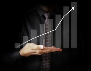 Businessman with financial symbols coming