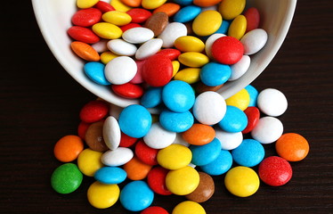 colored small chocolate colored pills in one heap
