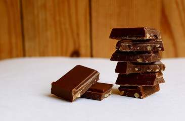 pieces of dark chocolate with nuts stacked in one pile