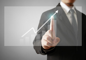 Businessman with financial symbols coming