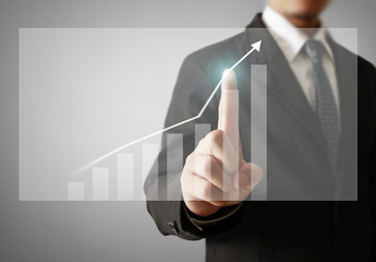 Businessman with financial symbols coming