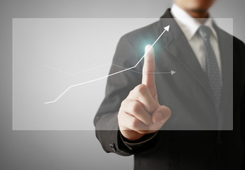 Businessman with financial symbols coming