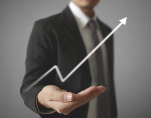 Businessman with financial symbols coming