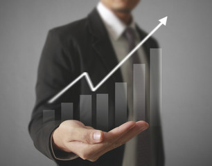 Businessman with financial symbols coming