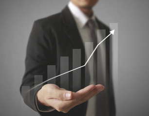 Businessman with financial symbols coming
