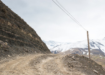 Gravel road passing into the mountain settlement