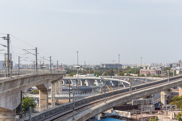 Fototapeta na wymiar Chennai india may 27 2018 wide view of metro train bridge seen with nearby national highway road (known as kathipaara junction near guindy)