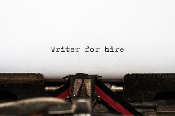 Message Writer for hire typed on white paper.  Antique typewriter has a nostalgic, honest fee....
