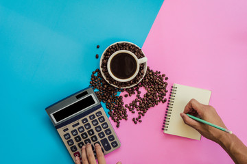 Coffee equipment calculator for business working on the color board with noodle, spoon, coffee beans and notbook.