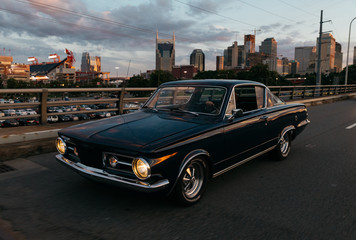classic car transportation driving across bridge in Nashville Tennessee at sunset