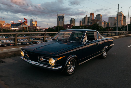 Fototapeta classic car transportation driving across bridge in Nashville Tennessee at sunset