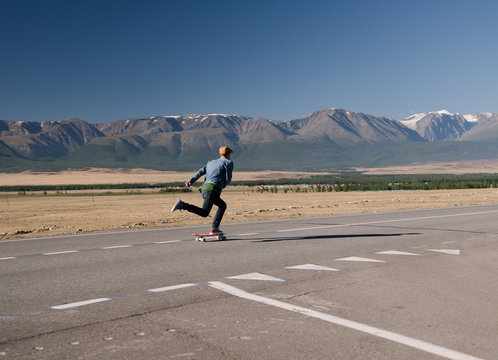 Man riding skateboard on rural rad