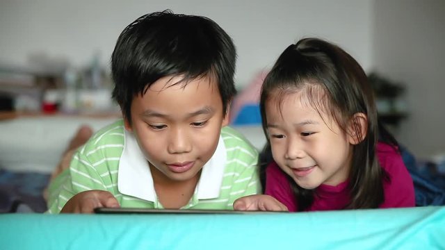 Asian children using digital tablet. E-learning concept.