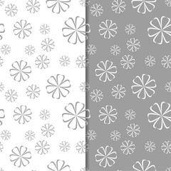 Fototapeta na wymiar White and gray floral backgrounds. Set of seamless patterns