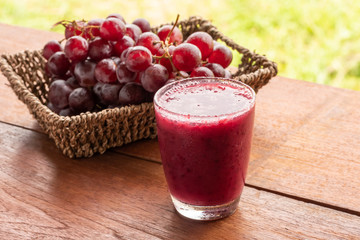 Glass of Grape juice smoothie on wooden table