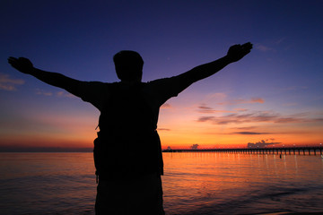 Fototapeta premium Silhouette of a man in the beautiful sunrise.