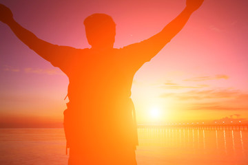 Fototapeta na wymiar Silhouette of a man in the beautiful sunrise.