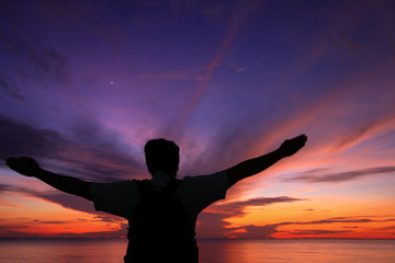 Fototapeta na wymiar Silhouette of a man in the beautiful sunrise.