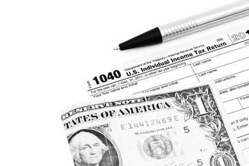 US Tax form with banknote an pen