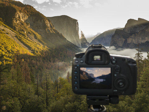 Camera on tripod shooting El Capitan and and Half Dome  from the tunnel entrance to the Valley at sunrise.