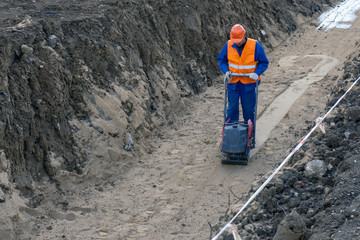 guest worker is building a trench sand stone earth