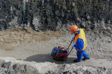 guest worker is building a trench sand stone earth