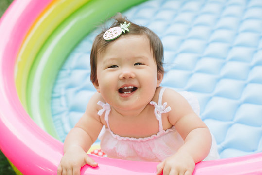 Baby playing in kiddie pool